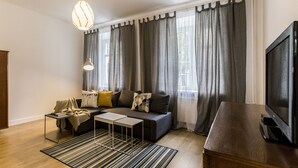 A modern living room with a sofa, coffee table, and TV. - Visit Lublin Premium Radziszewskiego (Lublin)