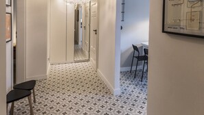 A hallway with patterned flooring, a decorative ceiling light, and a framed map on the wall. - Visit Lublin Premium Radziszewskiego (Lublin)