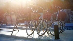 Bicycles parked next to a railing, with a sunlit background. - Da Jen Shan Style Resort (Hengchun)