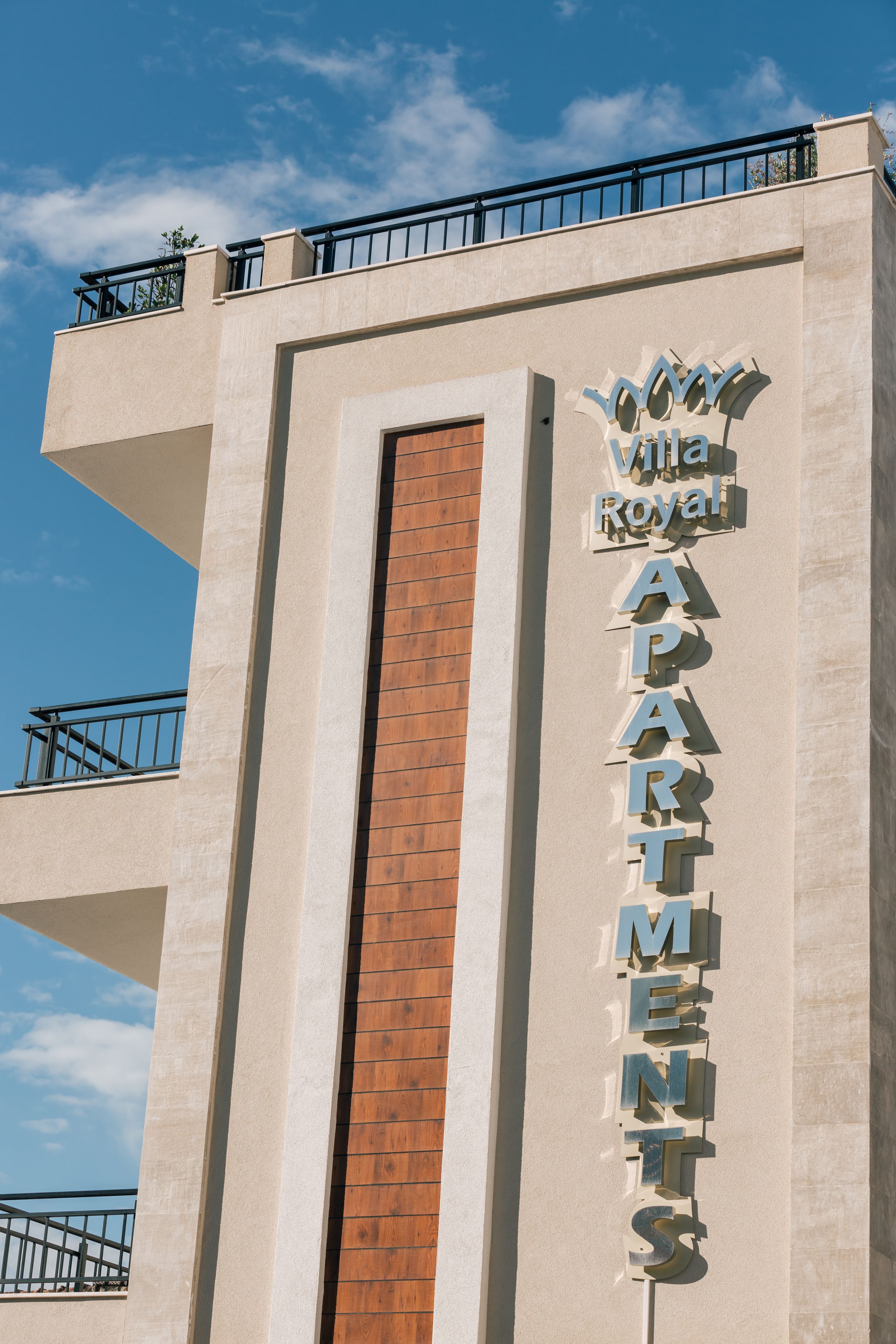 A building with a sign reading "Viva Royal Apartments."