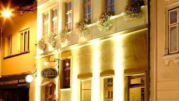 Een hotel met een klassiek gevelontwerp, meerdere ramen en een bord waarop staat dat het een hotel is.