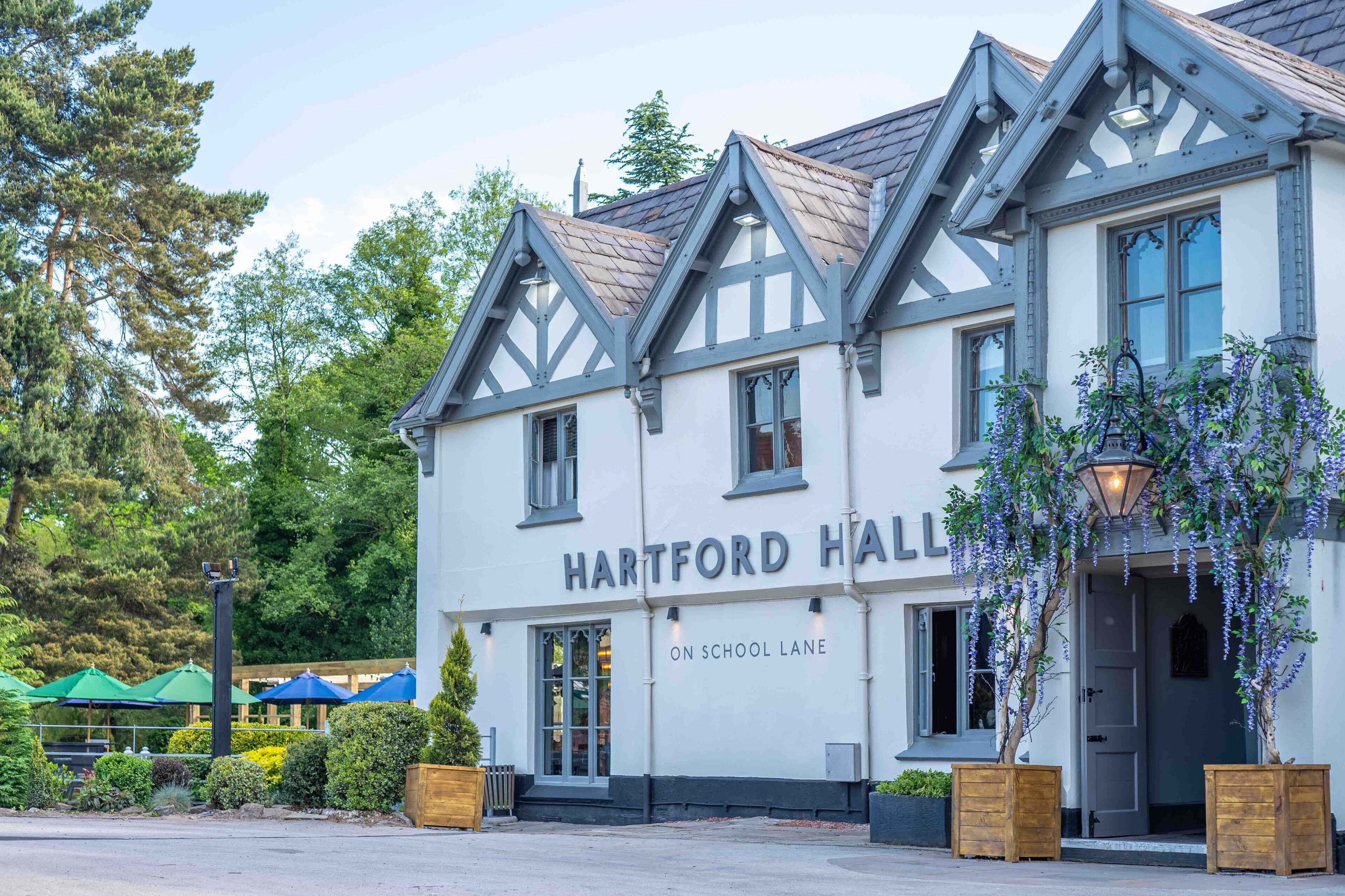 A traditional building with a sign reading "HARTFORD HALL" on the front.