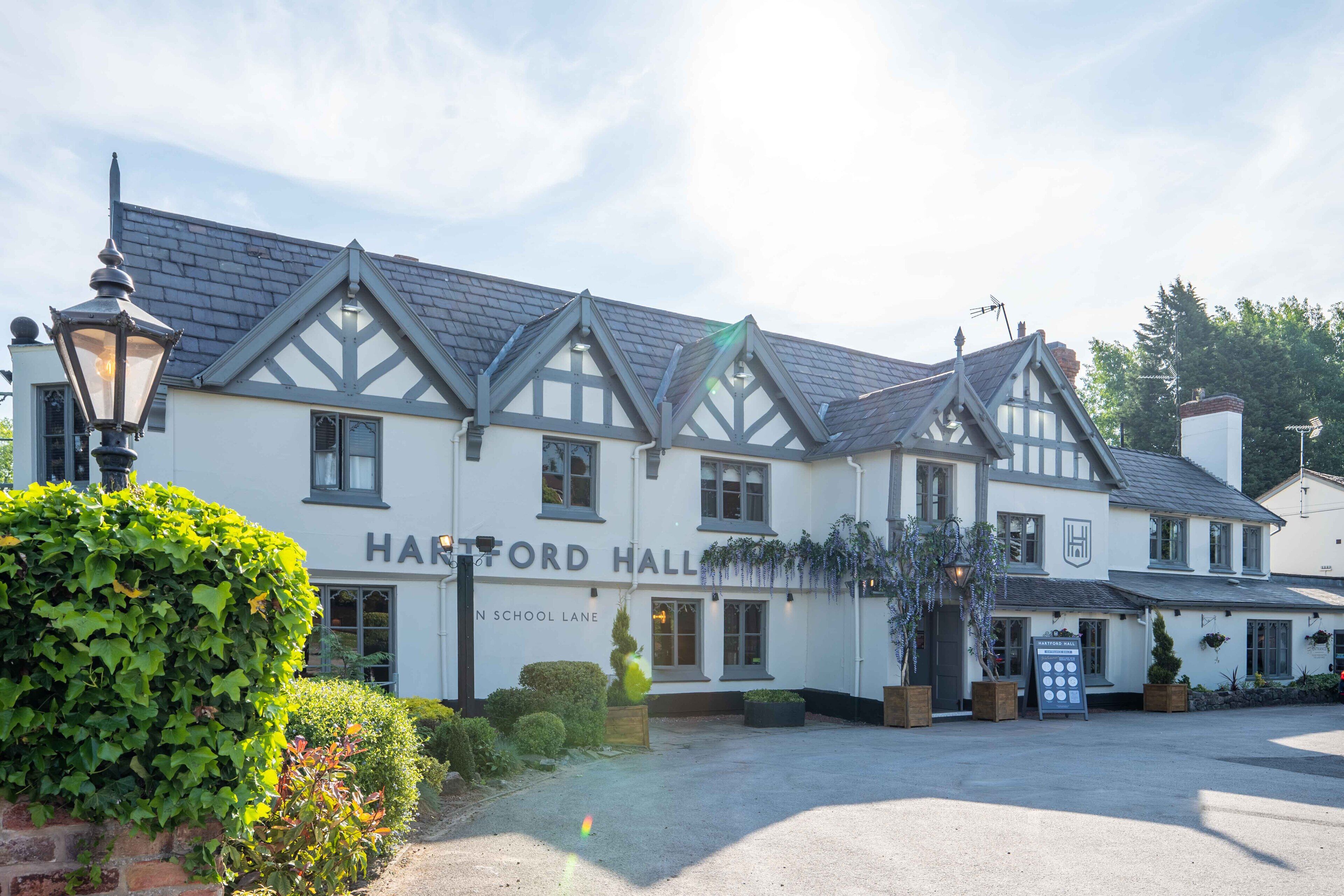A traditional building with a sign reading "HARTFORD HALL" on the front.
