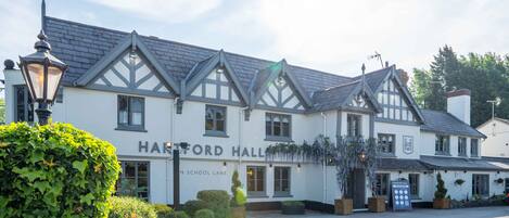 A traditional building with a sign reading "HARTFORD HALL" on the front.