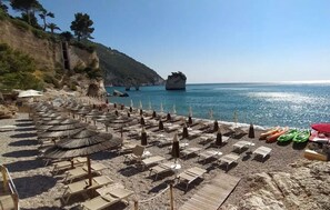 Private beach, white sand, sun loungers, beach umbrellas
