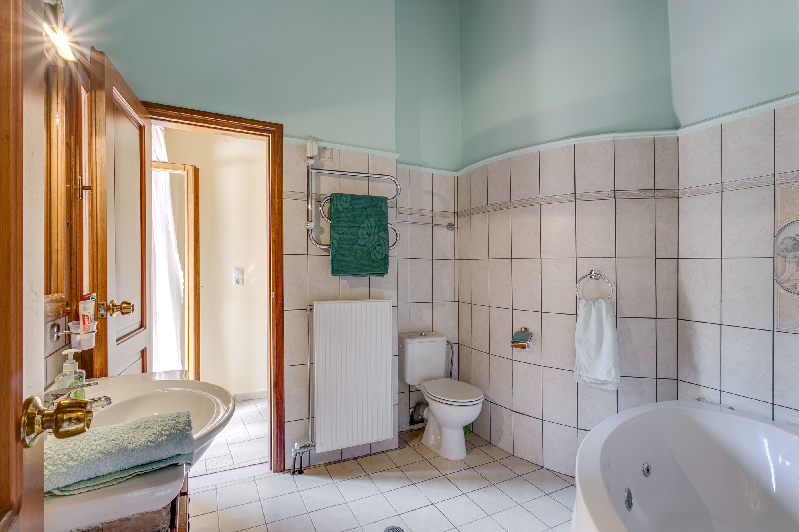 Kylpyhuone, jossa on pesuallas, wc ja kylpyamme.