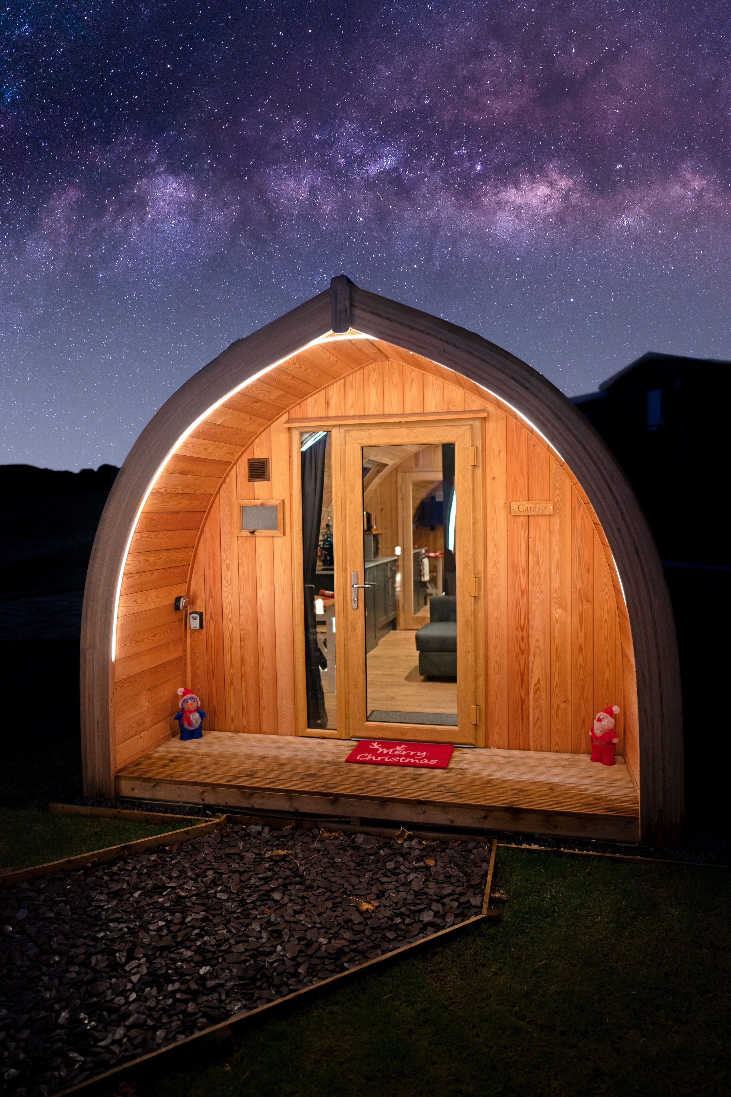 A wooden dome-shaped structure with a door leading inside.