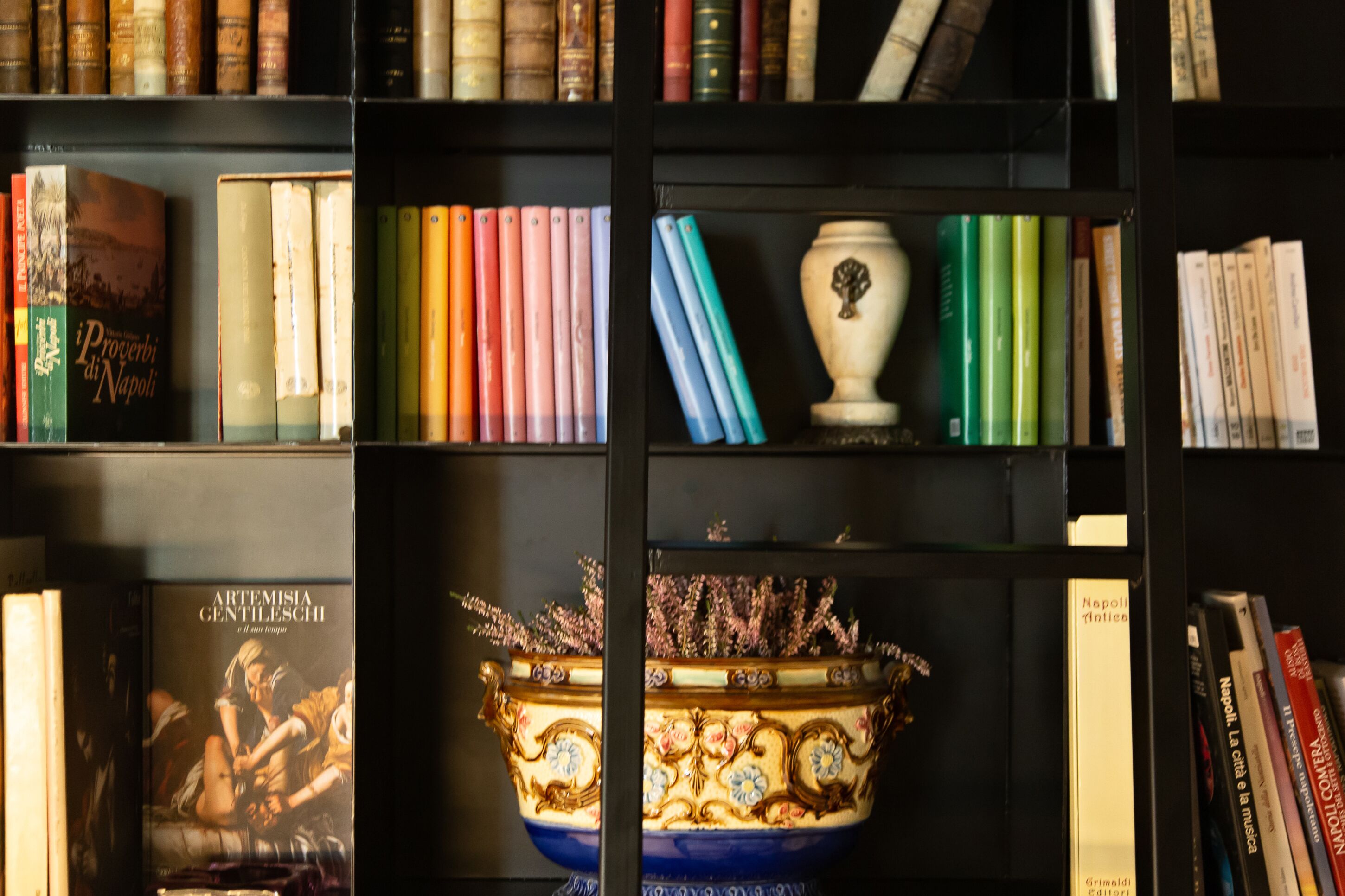 A bookshelf with books and decorative items.