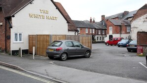 A building labeled "The White Hart" with a car parked in front. - White Hart, Andover by Marston's Inns (Andover)