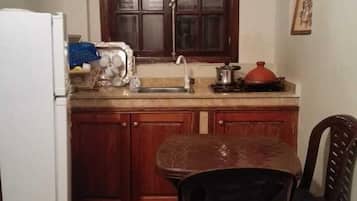 Apartment | Private kitchenette | Fridge, stovetop, cookware/dishes/utensils