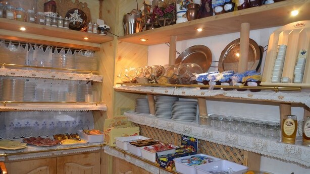 A buffet area with various food items and condiments. - Chalet Valeruz (Canazei)