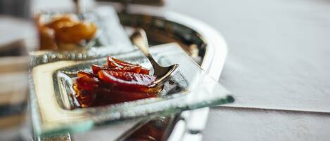 A glass tray with a dessert and a spoon.