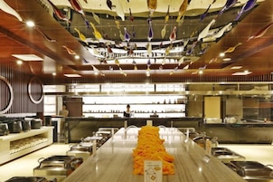 A buffet setup with a long counter and multiple food stations.