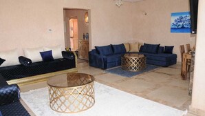 A living room with a sofa set, a coffee table, and a chandelier. - Villa Jasmine V4 70 Marrakesh (Marrakech)