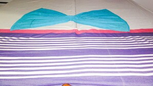 A double bed with a striped bedspread, two pillows, and a headboard. - Spring holiday (Mirissa)