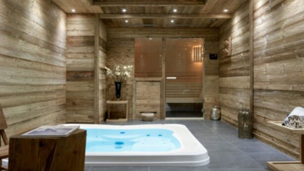 A wooden cabin interior with a hot tub, wooden walls, and a tiled floor. - Whistler Lodge Apartment T3 Cabin B07 (Courchevel)