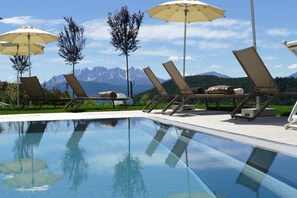 Outdoor pool, open 7:30 AM to 7:00 PM, pool umbrellas, pool loungers