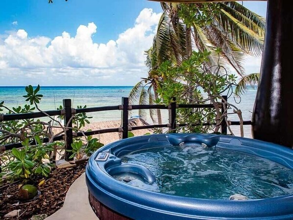 Un bain à remous avec vue sur la plage et l’océan.