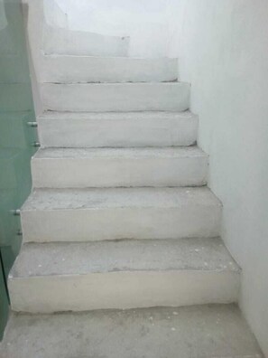 Staircase leads upwards through a neutral-colored space.
