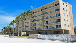A multi-story hotel with balconies, located near a beach. - Beachcomber unit 303 (Longboat Key)
