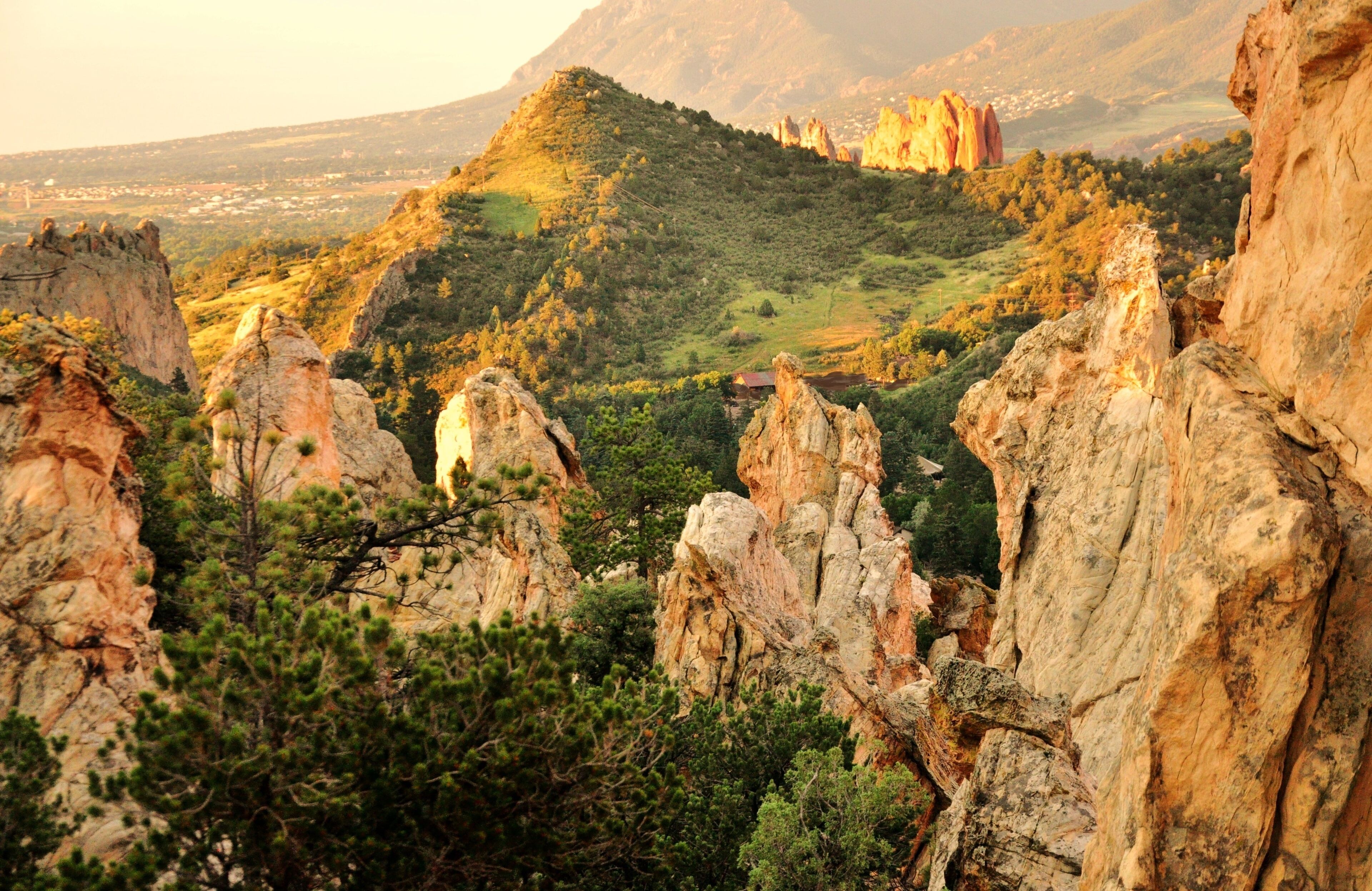 A mountainous landscape with rocky outcrops and dense greenery.