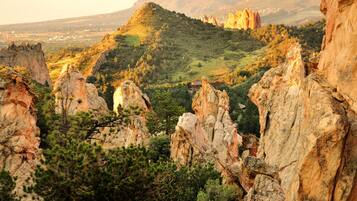 A mountainous landscape with rocky outcrops and dense greenery.