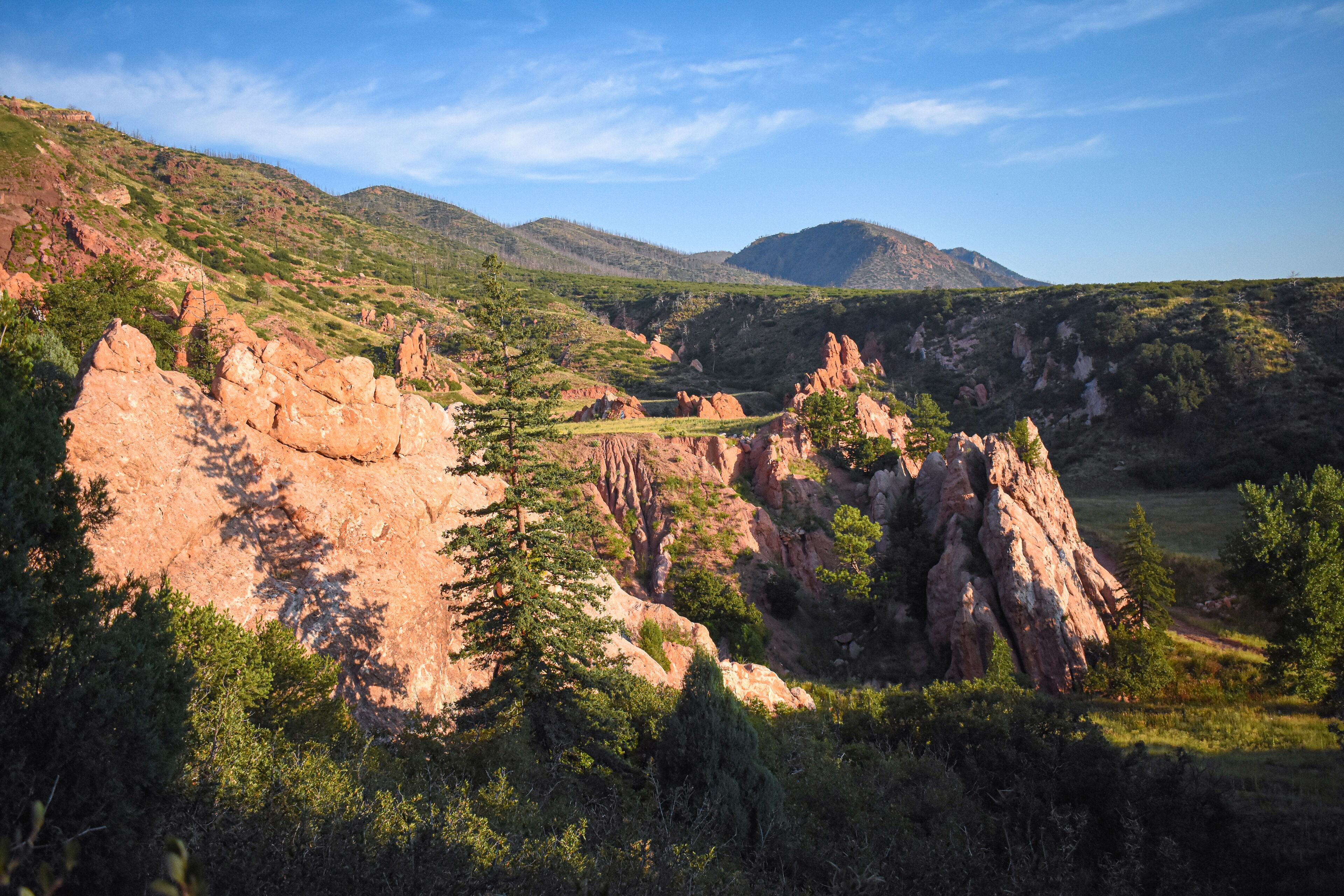 Paisagem montanhosa com formações rochosas e vegetação.