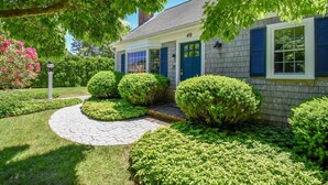 A house with a brick exterior, blue shutters, and a number 49 sign. - Central AC Close to Beach Dog Friendly! (Chatham)