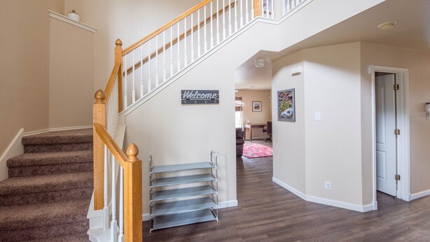A staircase with a wooden handrail and metal steps, leading to a landing with a 'Welcome' sign. - A Bit of Country, All the Perks of the City (Helotes)