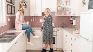 A modern kitchen with white cabinets, a pink tiled backsplash, and a white countertop. - Jasmine's Cottage Barossa Valley Vineyard Views (Barossa Valley)
