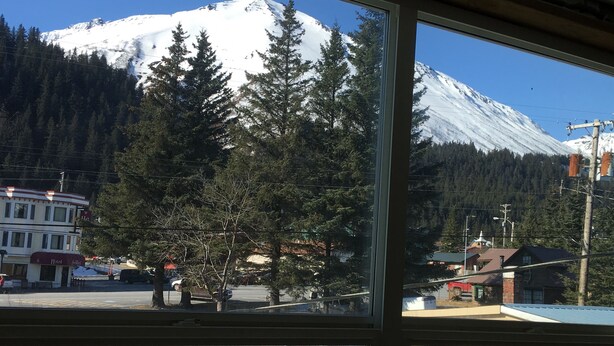 A hotel with a view of a snow-capped mountain.