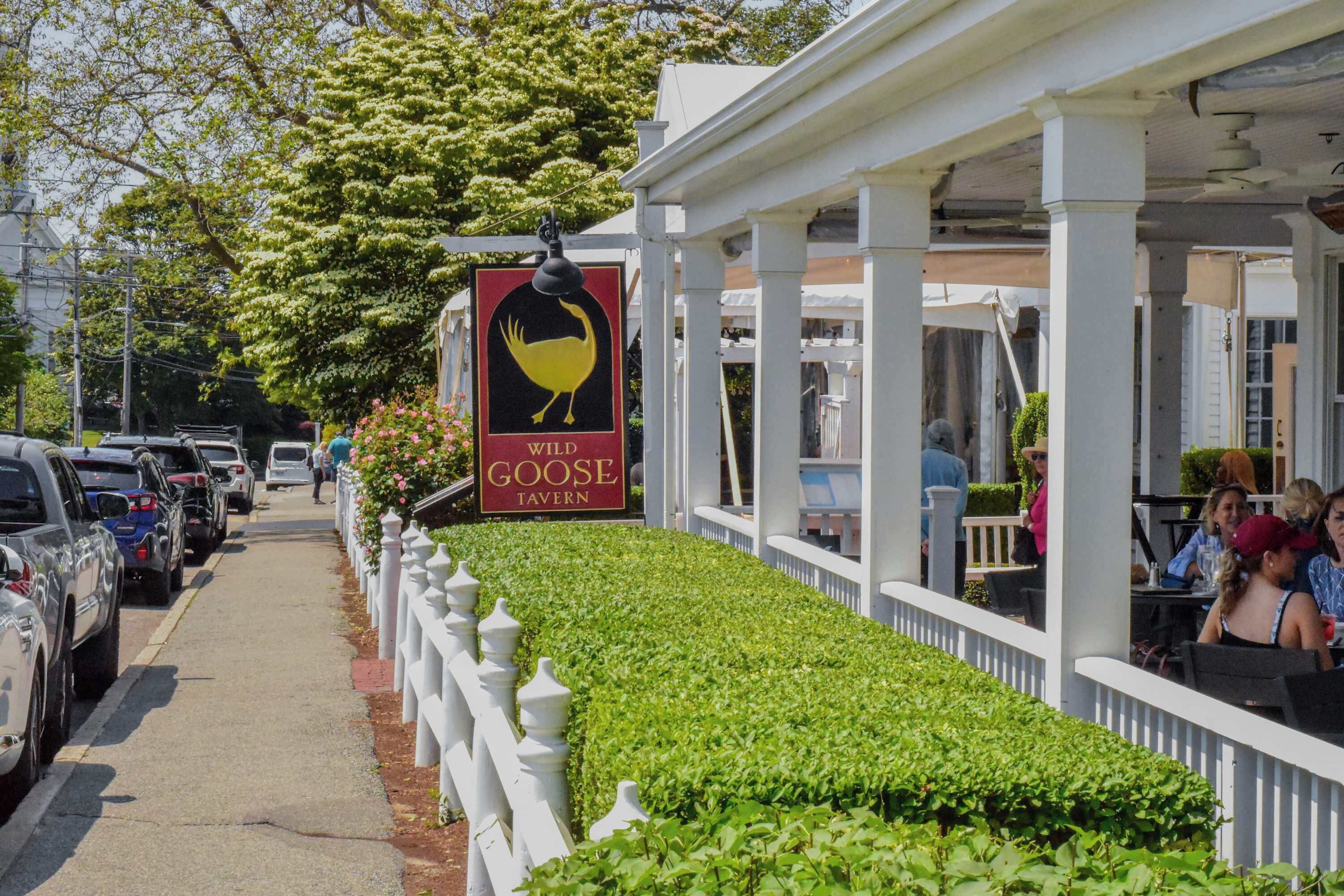 A street view of a restaurant with a sign for 'Wild Goose Tavern'.