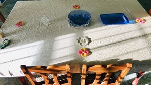 A dining table with a patterned tablecloth, a blue bowl, and a blue tray. - YOUR HOME AWAY FROM HOME (Vieux Fort)