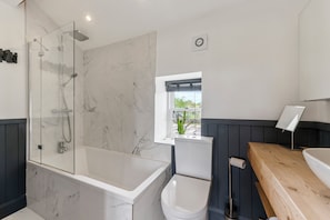 Combined shower/bathtub, hair dryer, towels, toilet paper