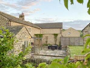 Relax in a serene courtyard surrounded by lush greenery and a patio.
