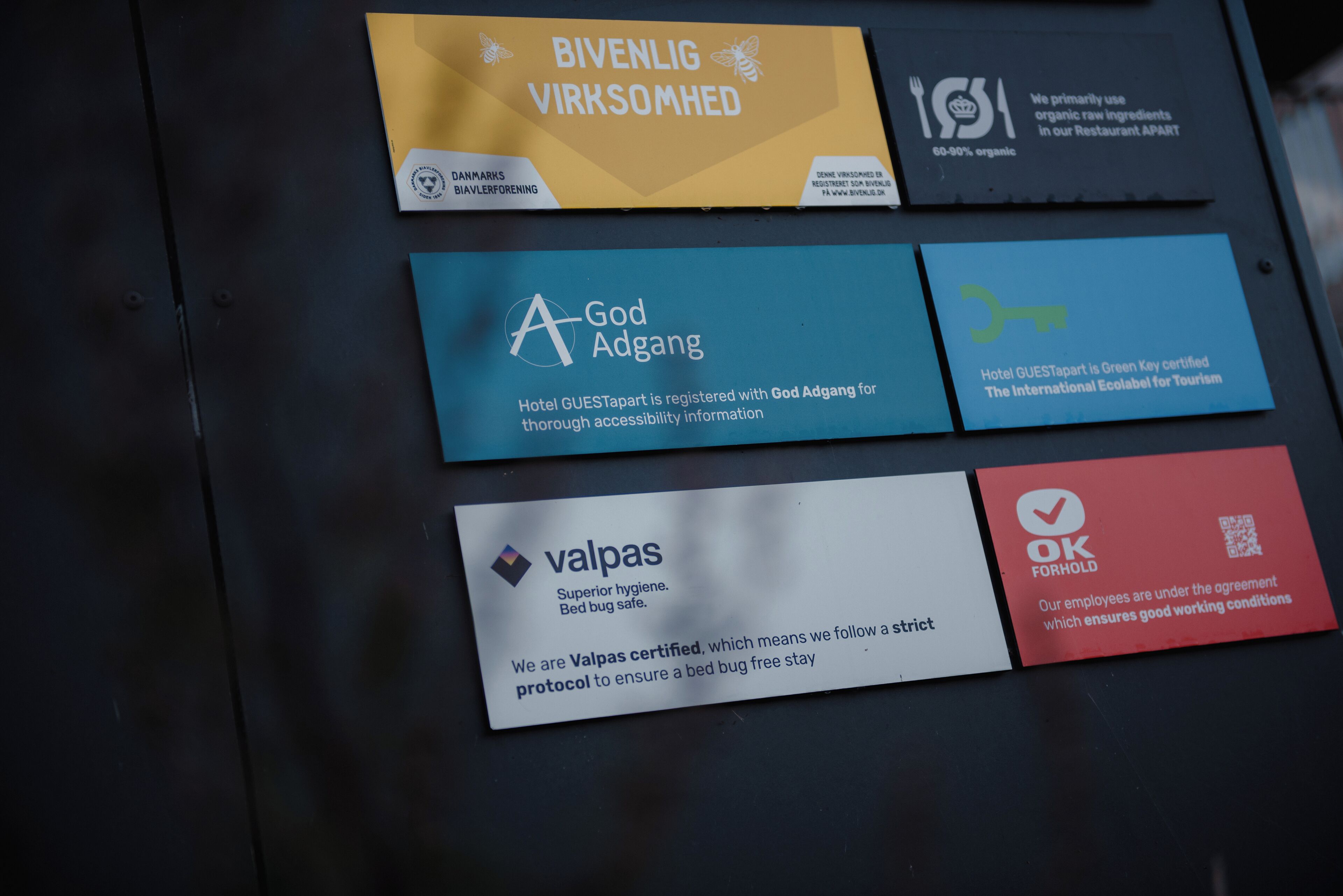 Four hotel certification badges on a wall.