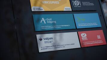 Four hotel certification badges on a wall.
