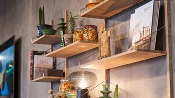 A shelf with various items including jars, a lamp, and decorative objects.