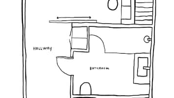 Plano de un hotel que muestra un balcón, sala de estar, pasillo, baño y cocina.