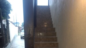 A staircase with tiled steps leading up to a landing. - CORREA PEREIRA RESIDENTIAL APARTMENT 3, sleeps up to 11 people, 3 bedrooms (CANELA)