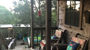 A wooden deck with outdoor seating and a pool area.
