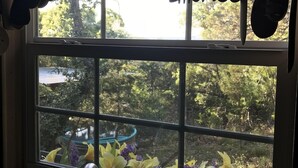 A kitchen with a window overlooking a garden.