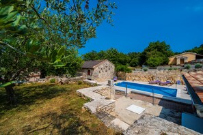 A stone house with a swimming pool, surrounded by trees and a stone wall. - LUXURY VILLA ON SPACIOUS PRIVATE PROPERTY  (Rakalj)