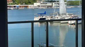 A marina with boats docked, a building with a sign, and a clear sky. - Hotel Port 110 (Ilawa)