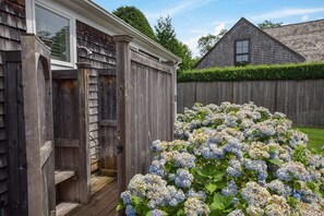 Step into a serene garden, complete with a charming shed and hydrangea flowers.