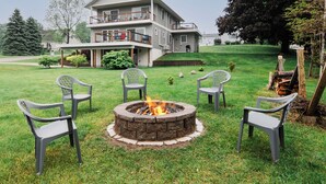A two-story house with a fire pit in the front yard surrounded by chairs. - Beautiful Cottage Overlooking Bear Lake (Bear Lake)
