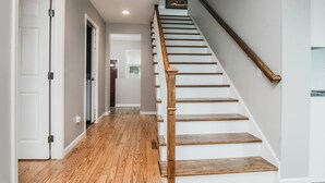 A staircase with wooden steps and a wooden handrail, leading to an upper floor. - Beautiful Cottage Overlooking Bear Lake (Bear Lake)