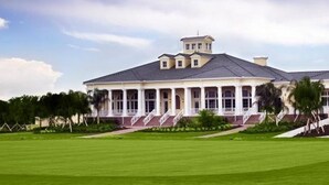 A large, single-story building with a flat roof and a central tower. - 5 STAR REVIEWED SOUTH FACING LUXURY GOLF AND DISNEY VILLA ON GATED COMMUNITY (Davenport)