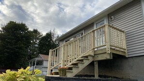 Una casa residencial con una escalera de madera que lleva a un balcón.