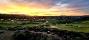 A golf course with multiple bunkers and a flagstick.